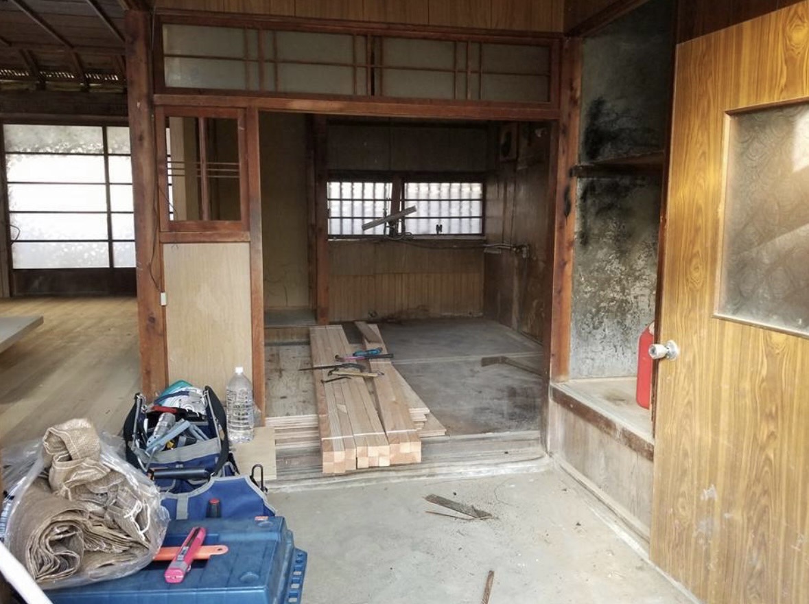 空き家だった古民家の改修作業 — 床材と工具が置かれた作業中の室内